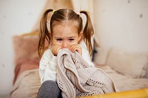 sleep rhythmic movement - little girl scared with blanket